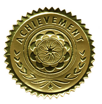 Photo of a golden medal with the word 'Achievement' engraved on the front.